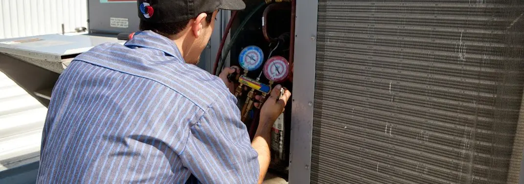 HVAC technician servicing a condenser unit in Fruitland Park